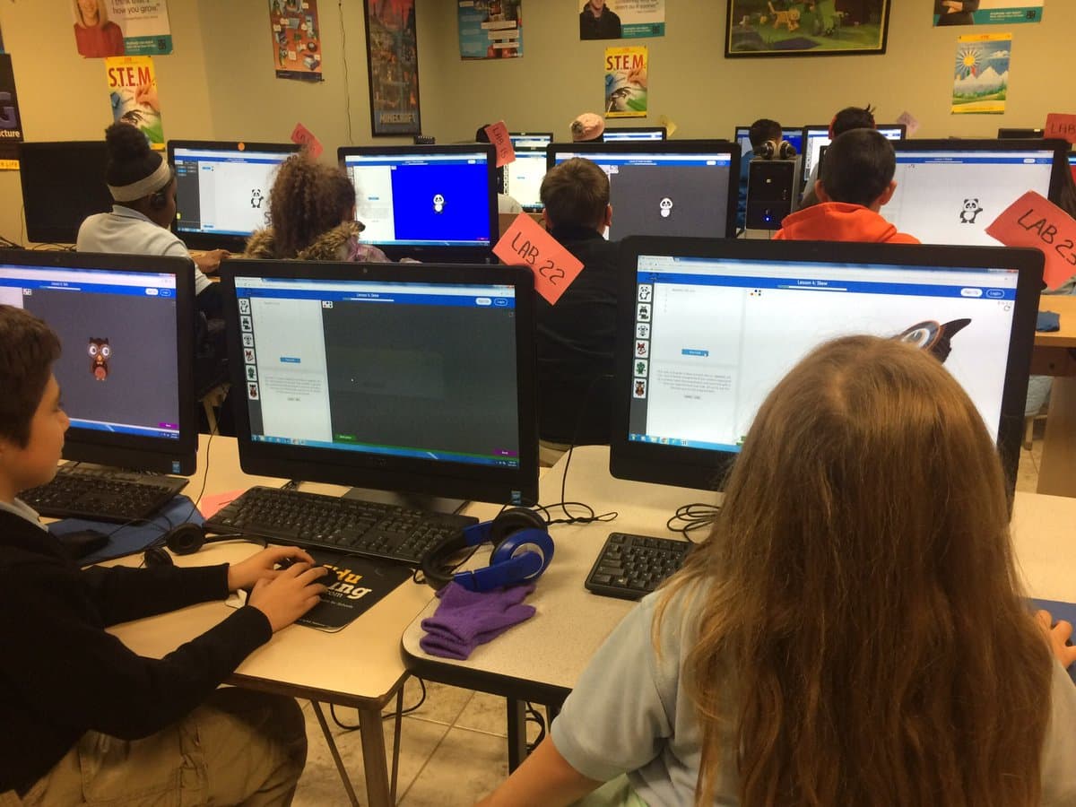 Students building Codemoji projects in a computer lab